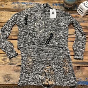 Super cute sweater. Great detail. Long in back.